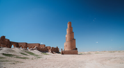 Exploring the ancient minaret and ruins in Abu Dulaf Iraq under a clear sky