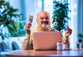 Senior Indian man finds discount on medicine via online shopping at home
