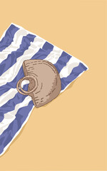 Blue stripes towel and beautiful crochet rustic beach bag on sand color 