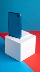 Modern blue smartphone on a white pedestal.