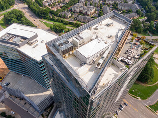 Sunny Daytime Drone Images of TPO Flat Roofs on Commercial and Residential Buildings in Raleigh...