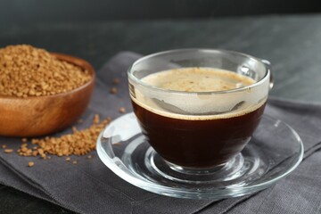 Aromatic instant coffee on black table, closeup