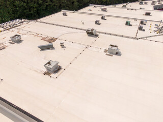 Sunny Daytime Drone Images of TPO Flat Roofs on Commercial and Residential Buildings in Raleigh...