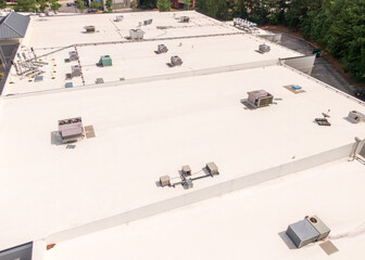 Sunny Daytime Drone Images of TPO Flat Roofs on Commercial and Residential Buildings in Raleigh...
