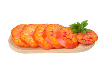 Sliced tomato on wooden plate isolated on white background with clipping path