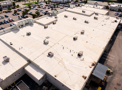 Sunny Daytime Drone Images of TPO Flat Roofs on Commercial and Residential Buildings in Raleigh North Carolina. 