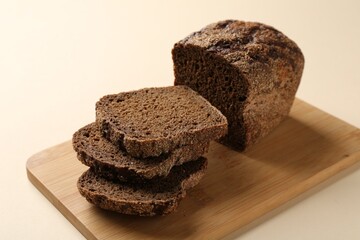 Pieces of fresh rye bread on beige background, closeup