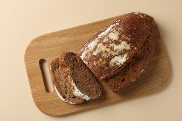 Pieces of fresh rye bread on beige background, top view