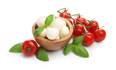 Tasty mozzarella cheese balls, tomatoes and basil isolated on white