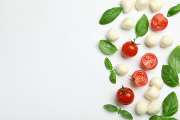 Tasty mozzarella cheese balls, tomatoes, basil and peppercorns on white background, flat lay. Space for text