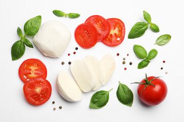 Tasty mozzarella cheese, tomatoes, basil and peppercorns on white background, flat lay