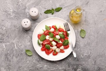 Tasty salad Caprese served on grey table, flat lay