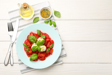 Tasty salad Caprese served on white wooden table, flat lay. Space for text