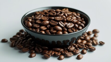 Fototapeta premium Bowl of coffee beans with some spilled on the surface.