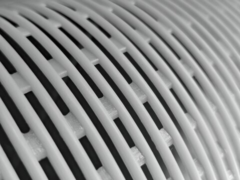 Abstract Monochrome Curved White Plastic Grid with Intersecting Lines and Shadows.
