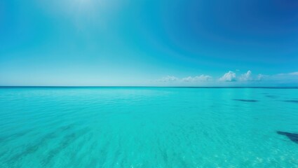 Vast ocean view with clear blue water and a bright sky.