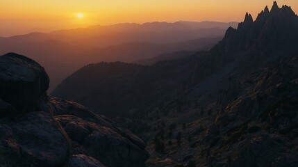 Golden Sunset View Over Mountain Peaks and Rugged Rock Formation