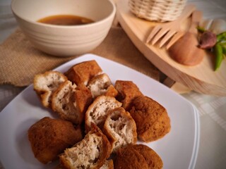 Crispy Tofu Delight Golden Brown Cubes with Savory Dipping Sauce.