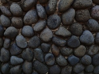 Dark Volcanic Rock Wall Texture Natural Stone Background CloseUp Detail.