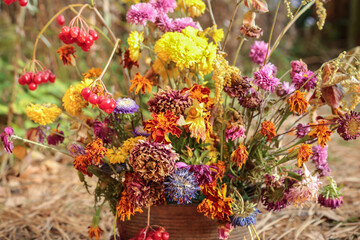 Withered autumn pink yellow orange red purple bouquet. Dry dying wilted fall flowers close up