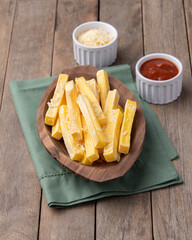 Crispy polenta fries over wooden table