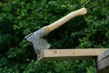 Finnish axe in green forest  