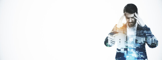 Stressed businessman in double exposure with cityscape overlay on white background, symbolizing pressure and urban work stress concept.