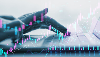 Hands typing on laptop with financial stock market graphs overlaid in abstract digital interface background in fintech business environment.