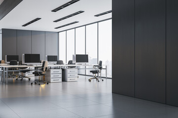 Modern empty corporate office interior with sleek design, work desks, chairs, and blank black wall...