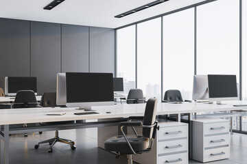 Modern minimalist office interior with sleek white desks, ergonomic chairs, and large windows...