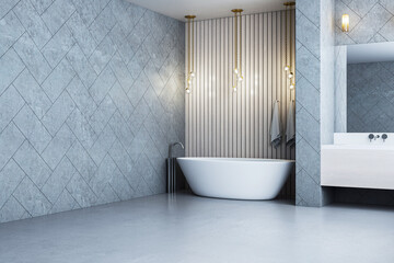 Modern elegant bathroom interior with freestanding bathtub, grey tiled walls, hanging lights, and...