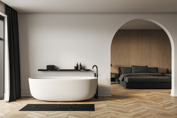Modern luxury bathroom and bedroom interior with wooden floor, chic bathtub, and elegant arched...