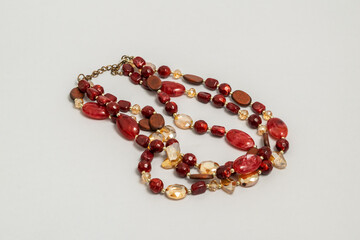 Multi strand red bead necklace isolated on grey background