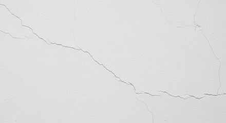 Subtle cracks spiderweb across a smooth, off-white surface.