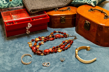 Treasure chests with various gold jewelry, bracelets, watch and pearls