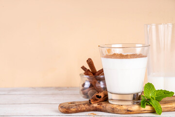Cinnamon honey milk drink. Dreamy Nighttime Drink, night time warm, relaxing and delicious cinnamon dairy or non-dairy beverage with honey and cinnamon powder, copy space