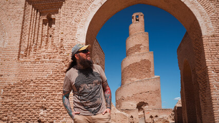 Tourist exploring ancient architecture in Iraq during a bright sunny day