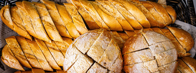 Fresh fragrant breads on the table. Bakery food concept panorama or wide banner photo background