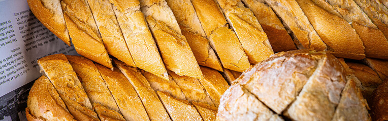 Fresh fragrant breads on the table. Bakery food concept panorama or wide banner photo background