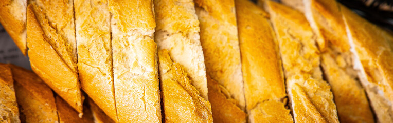 Fresh fragrant breads on the table. Bakery food concept panorama or wide banner photo background