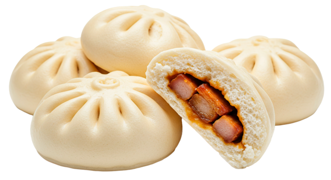 A group of steamed buns with one cut in half revealing a pork filling on a black background scene shot