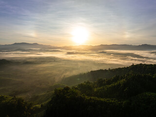 Drone view colorful clouds sunrise sky and fog over mountains.
