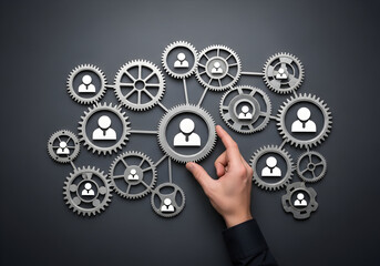 Hand connecting teamwork gears in business network concept