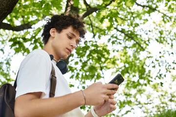 Young man enjoys a serene moment in a lush green park on a sunny summer day