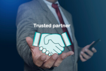 Partnership or mutual trust, handshake concept. businessman holding digital handshake icon, representing reliable cooperation