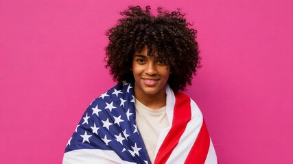 Young African American person with an afro hairstyle wrapped in the American flag. Patriotic concept with a vibrant pink background. - Powered by Adobe