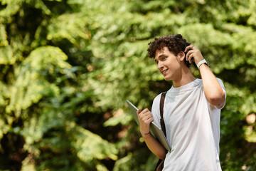 Young man enjoying a sunny afternoon in a vibrant green park while relaxing