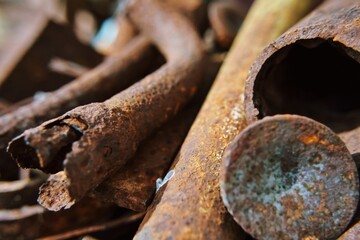 Metal rods. Diverse old rusty scrap metal from different items close-up. Collection and delivery of scrap metal. Abstract Background. Soft focus, defocus