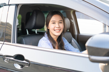 Transport, happy smile brunette hair asian young woman hand holding steering wheel driving car,...