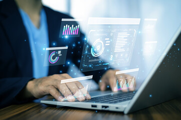 Business professional using AI tools on laptop to visualize analytics, optimize data strategy, and...